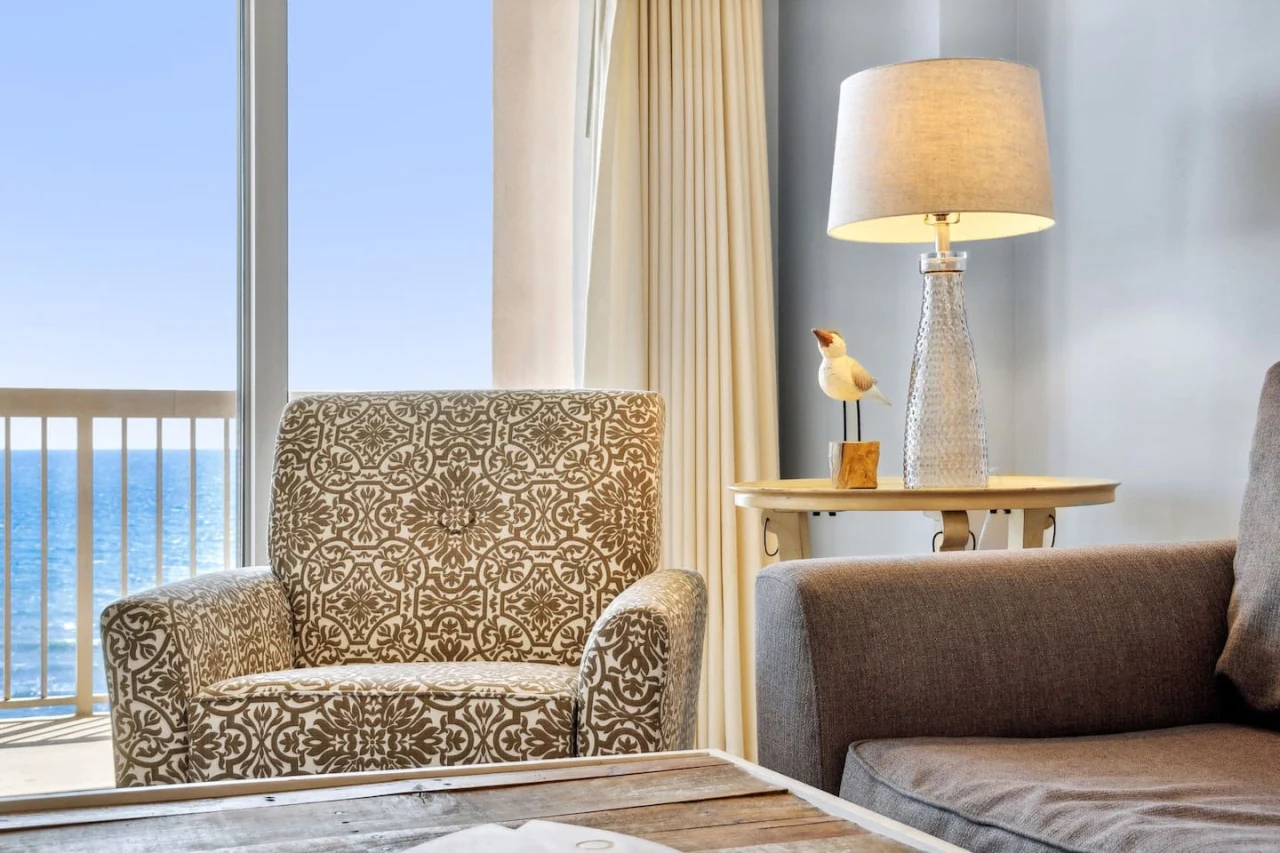 A comfortable reading chair beside an ocean-view window